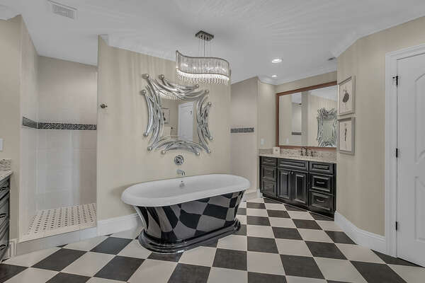 This ensuite bathroom features a garden tub, walk in shower and two sinks