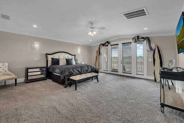This luxurious master bedroom features a King bed, private balcony and SMART TV