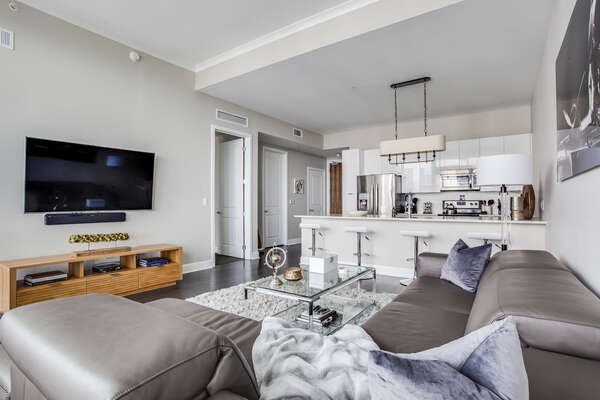 Living area with views of TV and kitchen
