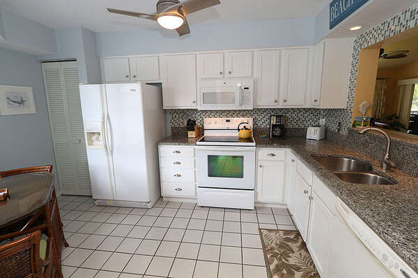 Renovated kitchen with Granite counters and beadboard cabinets.