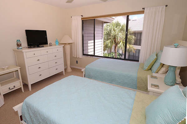 Guests can rest easy in this beach style bedroom