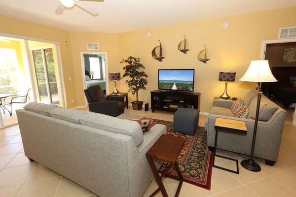 Living room with access to lanai and TV