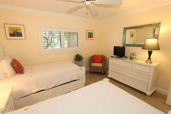 Guest bedroom has twin beds and natural light.