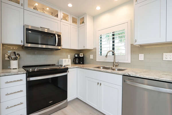 Upscale kitchen with illuminated upper glass door cabinets and under lit cabinets