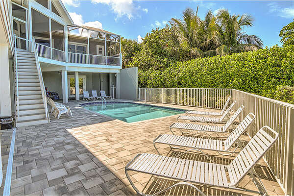Large pool and patio area with loungers for those sun bathers!