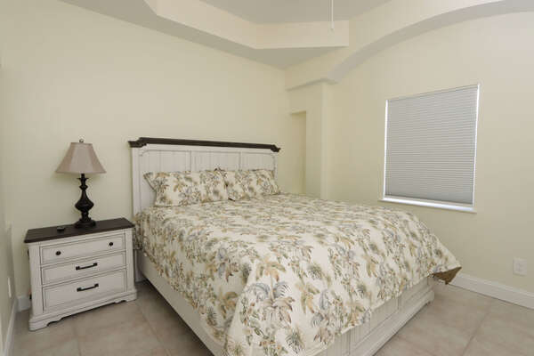 First floor guest bedroom with (1) queen bed