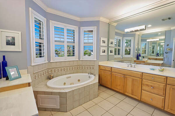 Master bathroom with dual vanity and a soaker tub