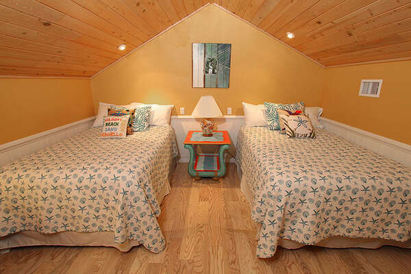 Twin beds in the loft bedroom area.