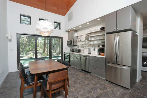 Kitchen with stainless steel appliances and dining table