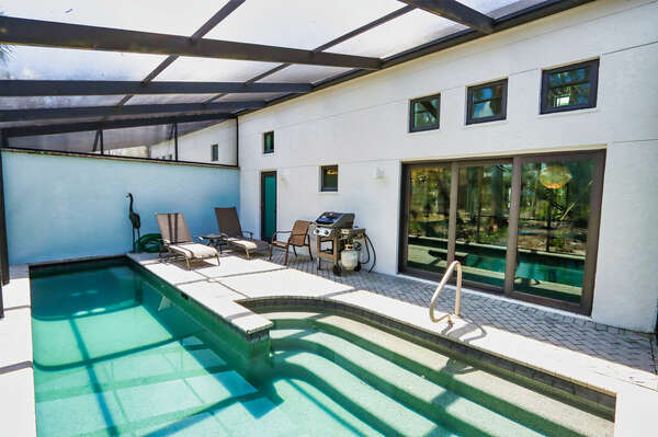 Pool area with grill and sun loungers