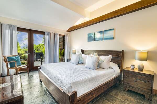 Bedroom with Access to a Private Lanai, Large Bed, and Chair