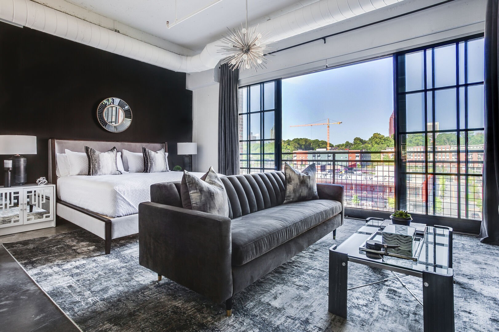 Living and Sleeping are comfortable on the bed and sofa in this Ponce City Market rental.