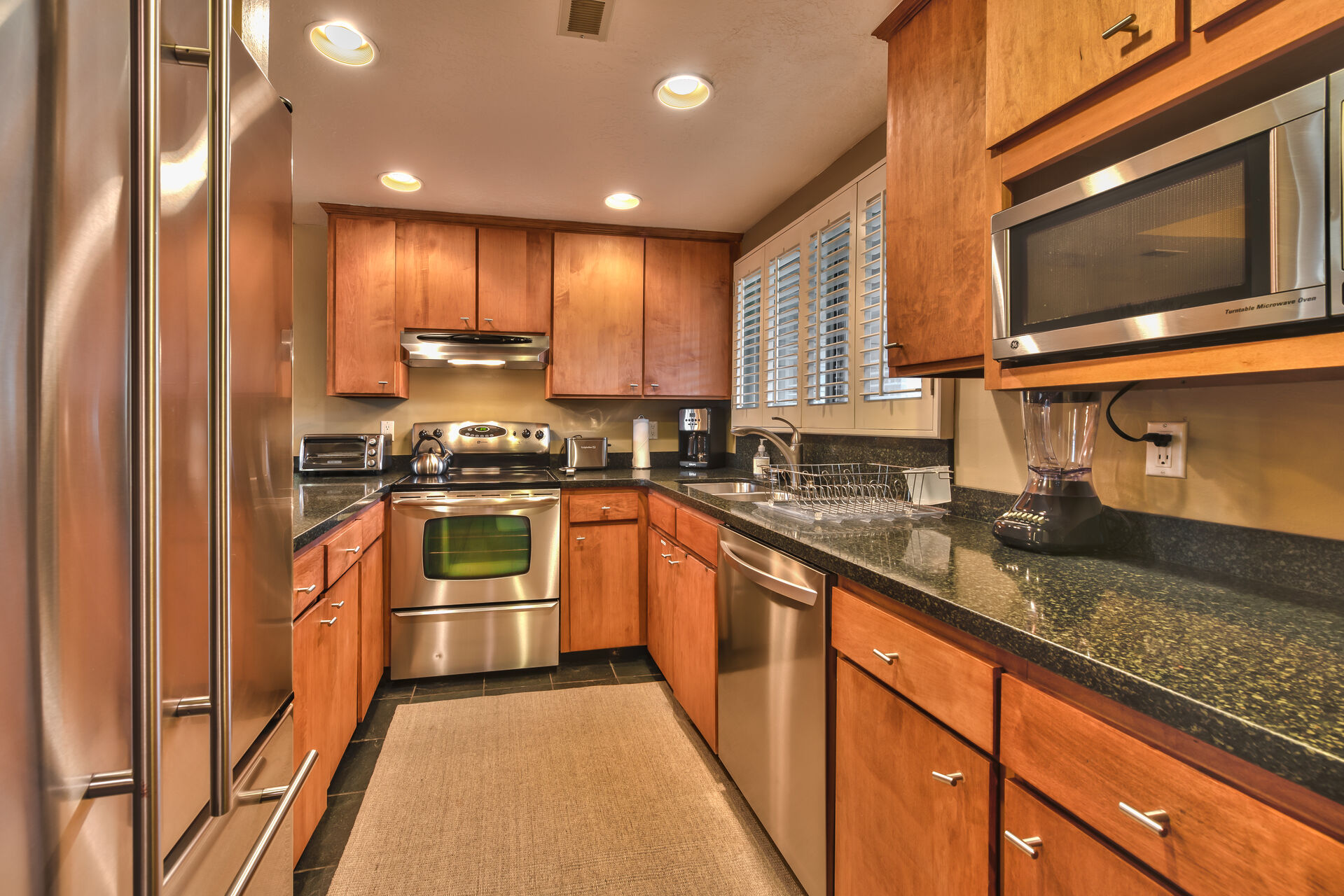 Fully-Equipped Kitchen with Granite Counters and Stainless Steel Appliances including a Jennair Refrigerator