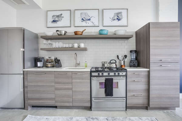 Picture of the kitchen of this Apartment Near Ponce City Market, with modern appliances and ample cabinetry.