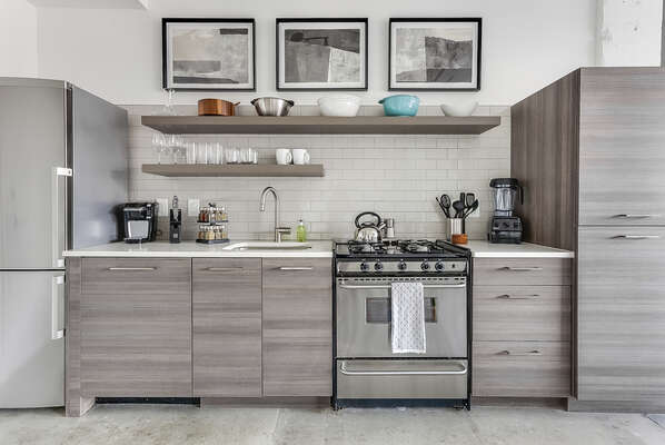 A full picture of the kitchen of this Ponce City Flat, complete with modern appliances and ample cabinetry.
