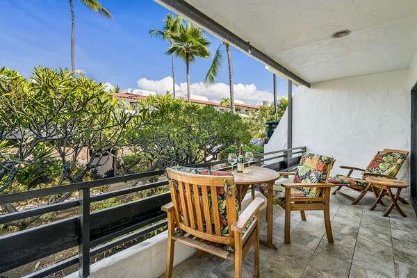 Spacious lanai with seating for three at this Kona oceanfront rental