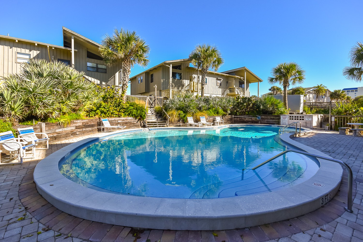 Community Pool with tropical landscaping