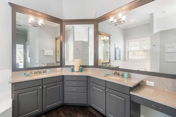 The master bathroom has a large walk-in closet, shower and his and her sinks