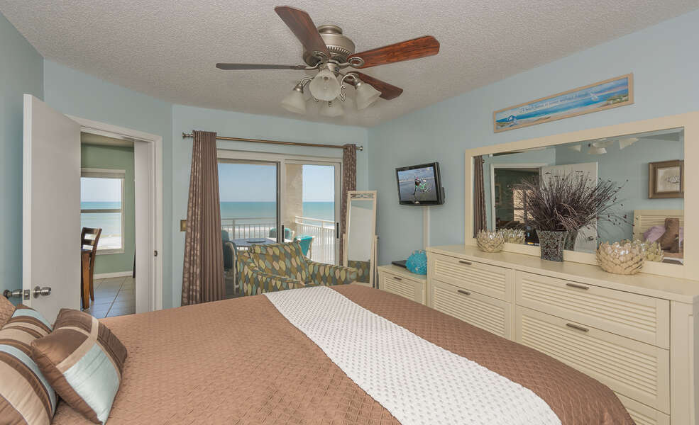 The master bedroom is ocean front  with sliders that open up onto the balcony.