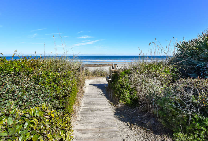 Wooden walkway to beach with landscaping