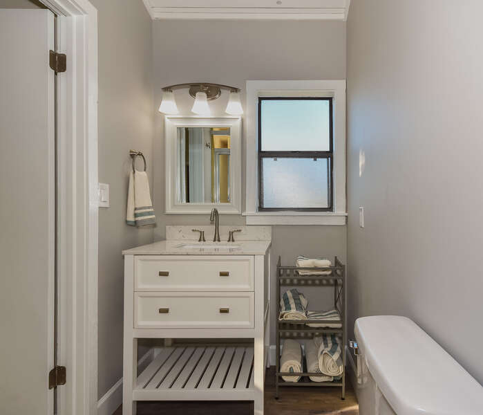 Bathroom with single vanity and extra shelving