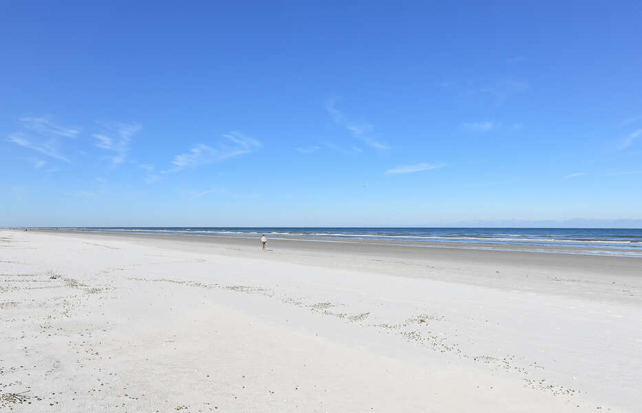 White sandy beach with blue sky