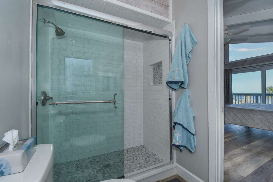 walk-in shower with tiled floor and walls