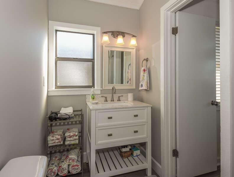 Bathroom with single vanity and extra shelving