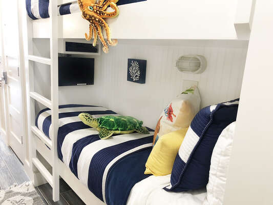 Super fun kid's bunks in hallway!! These are narrow, so ideal for kids! Built in TV! Kids LOVE these bunks and sea creatures!!