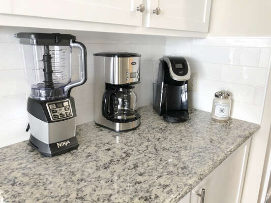 Full dry bar with Ninja Blender, Coffee pot AND a Keurig! Yankee candle shown here, too! Additional fridge built in the cabinets and plenty of drinkware for all kinds of drinks!