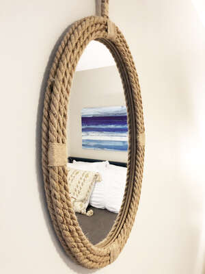 The beach doesn't care what you look like... but in case you do... check out this super cute mirror in the bedroom!