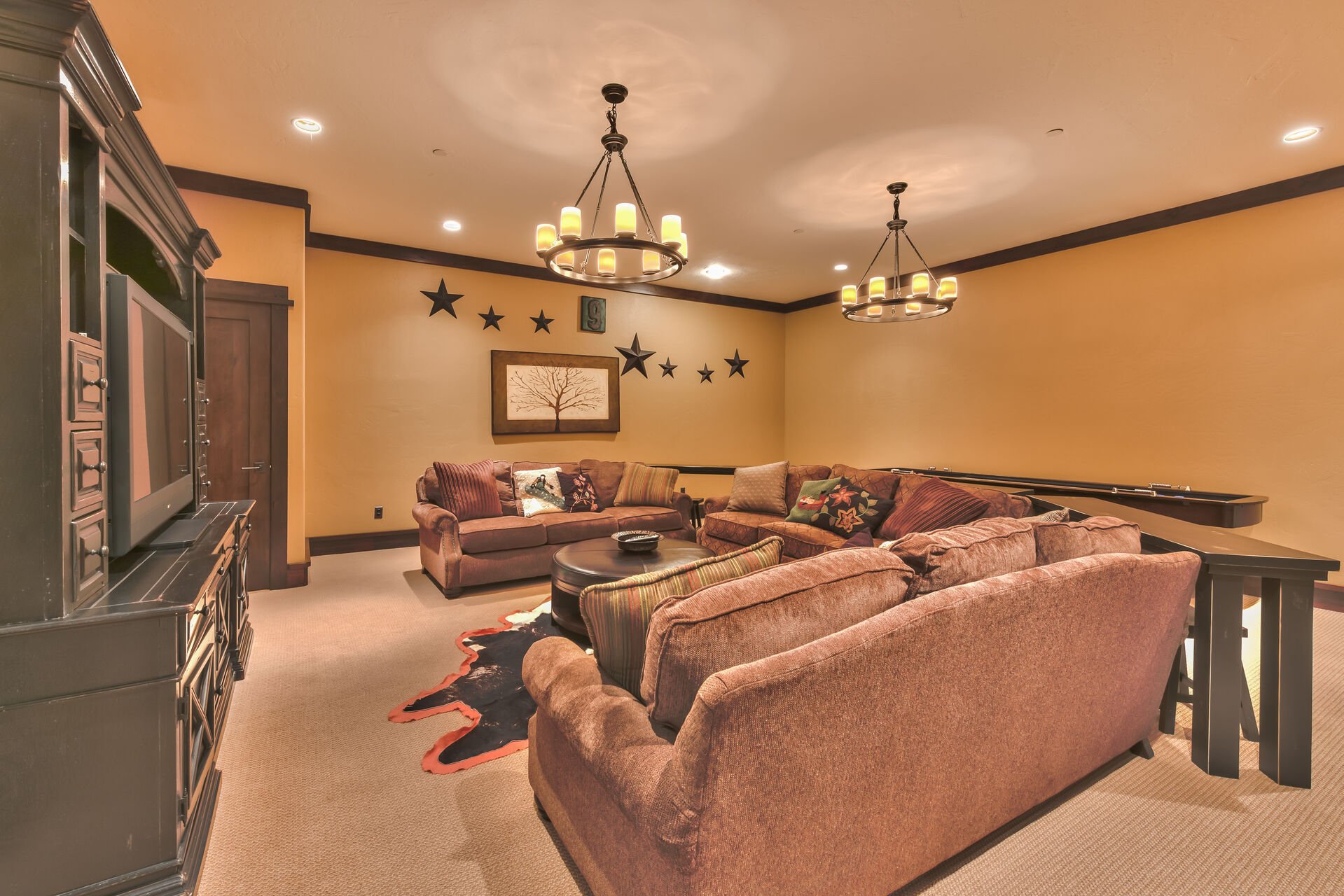 1st Level Theater/Game Room with Comfortable Furnishings, Including a Sleeper Sofa, Large Flat Screen TV and a Shuffleboard Table