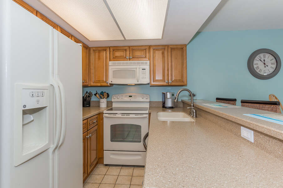 The fully equipped kitchen features GE appliances and everything you'll need to prepare your families favorite seaside dish.
