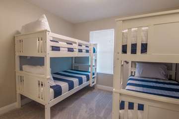 Simplistic, nautical atmosphere in guest, twin bunk bedroom upstairs