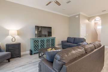 Open living room space with a brand new entertainment center and living room furniture providing plenty of seating for all your companionship