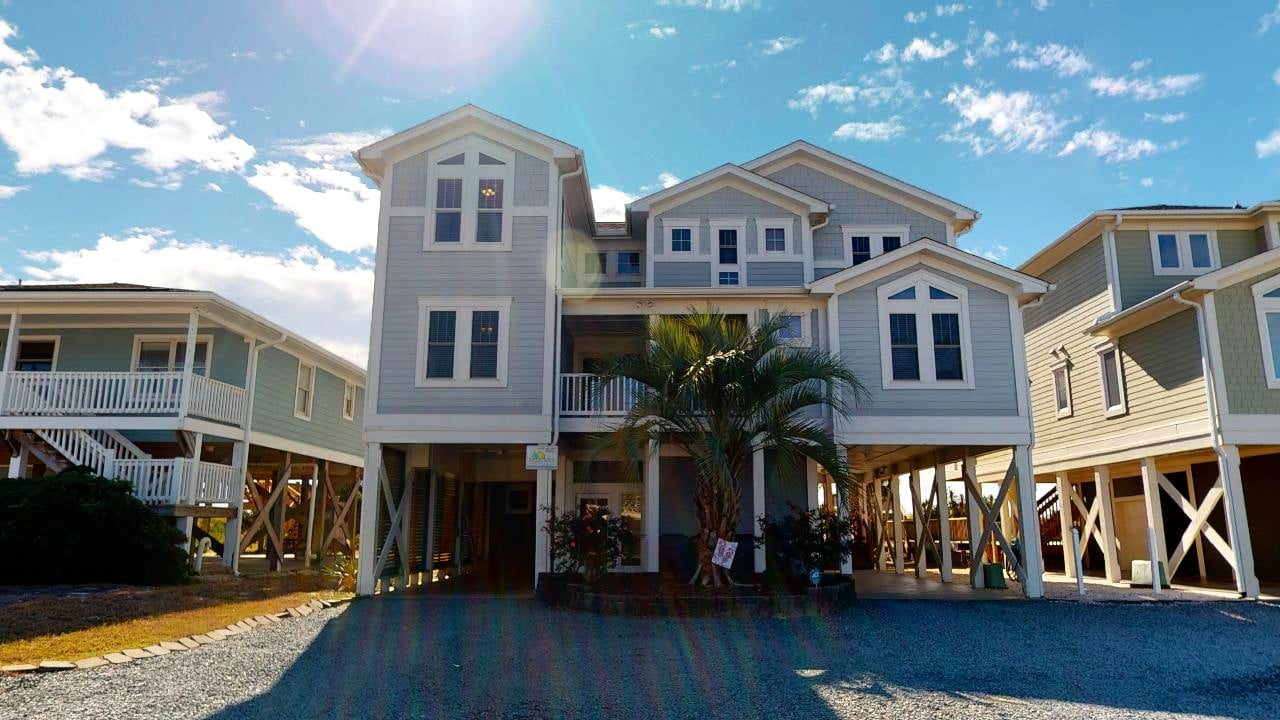 The beach side view of a vacation rental home in Holden Beach.