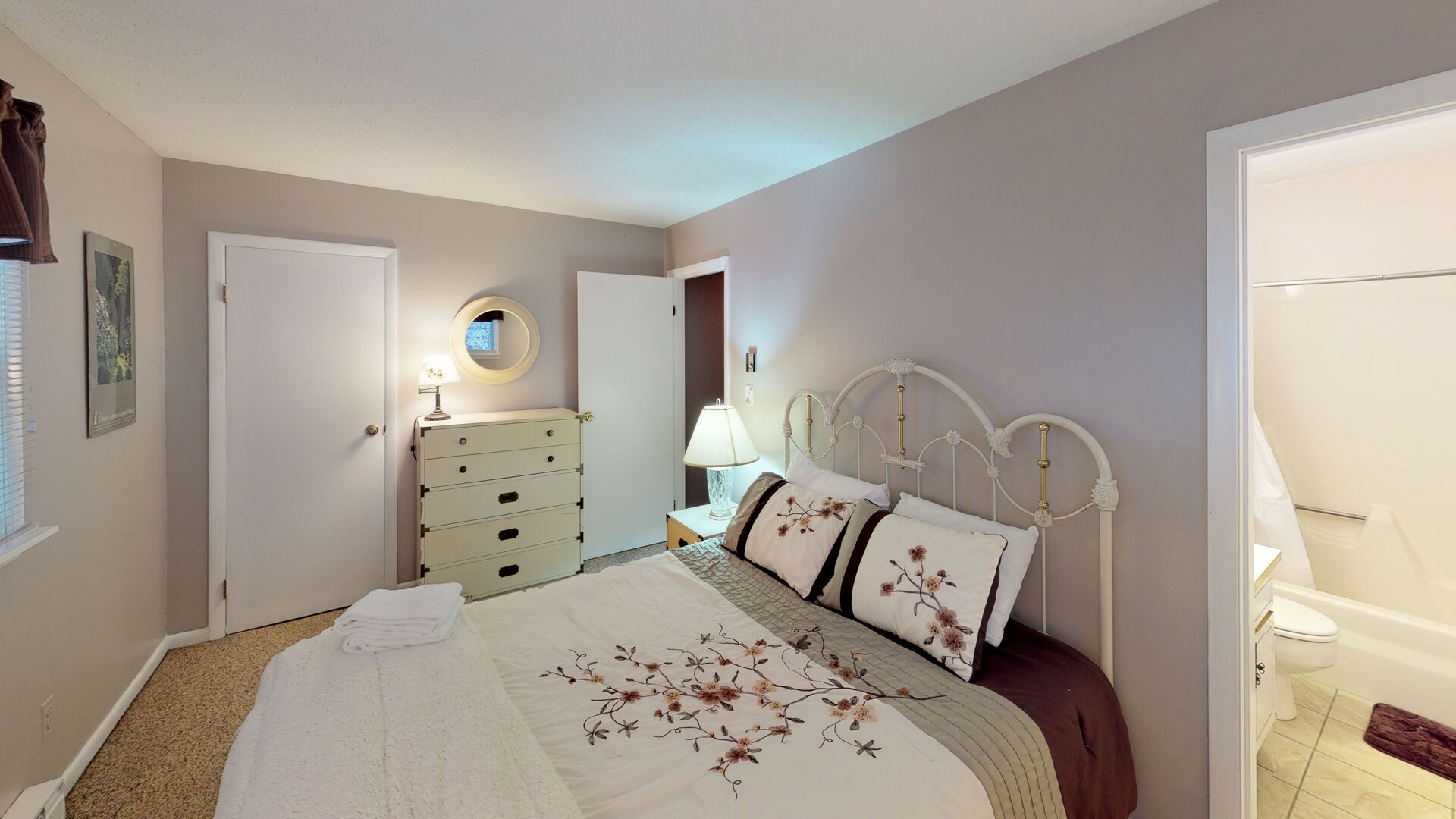 Lower level bedroom room with queen bed and private full bath