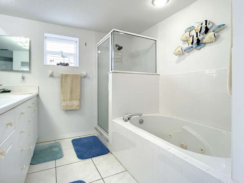 Master Bathroom - Large walk-in shower with glass doors, jetted bath tub and his and her sinks.