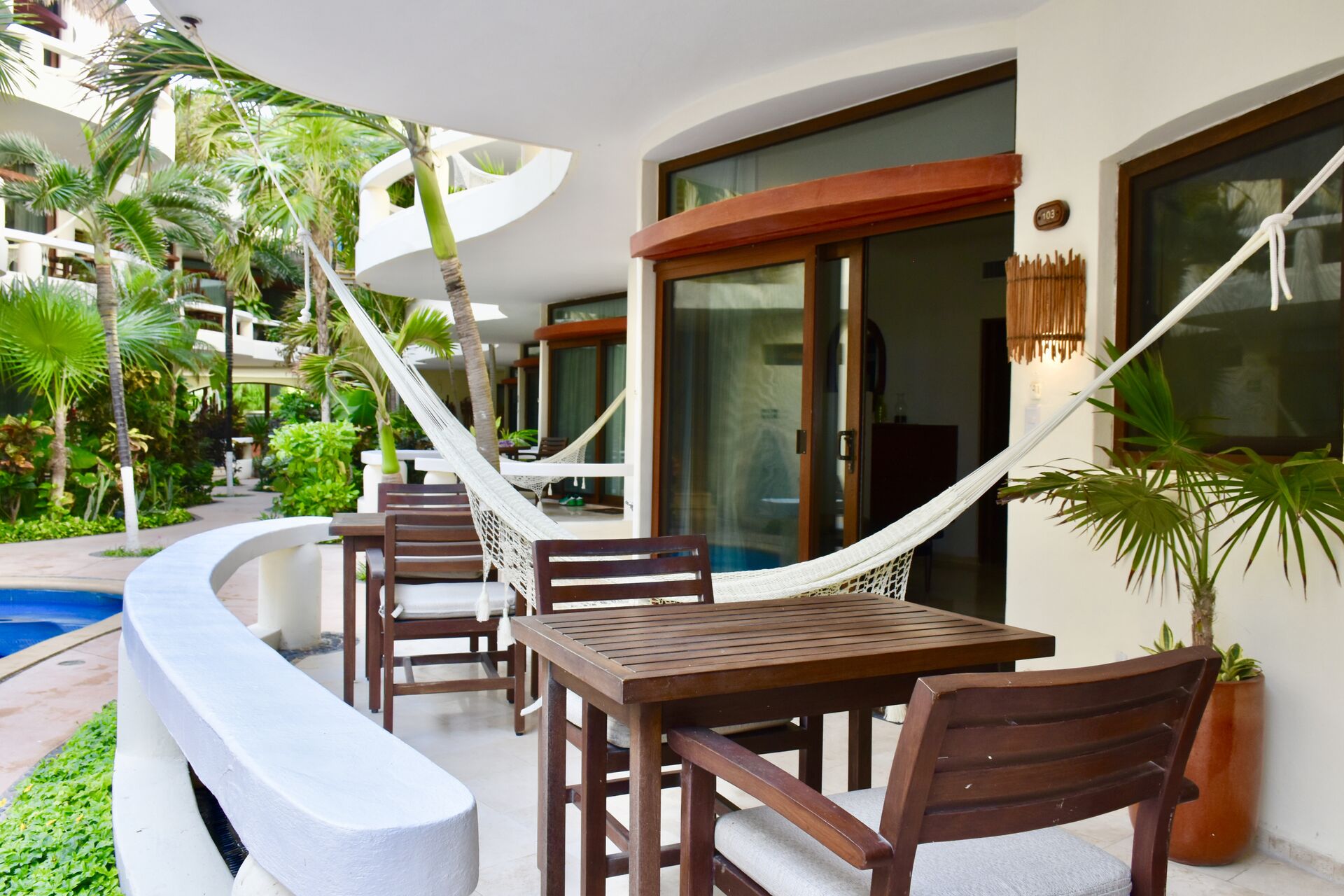 Balcony with chairs and hammock.