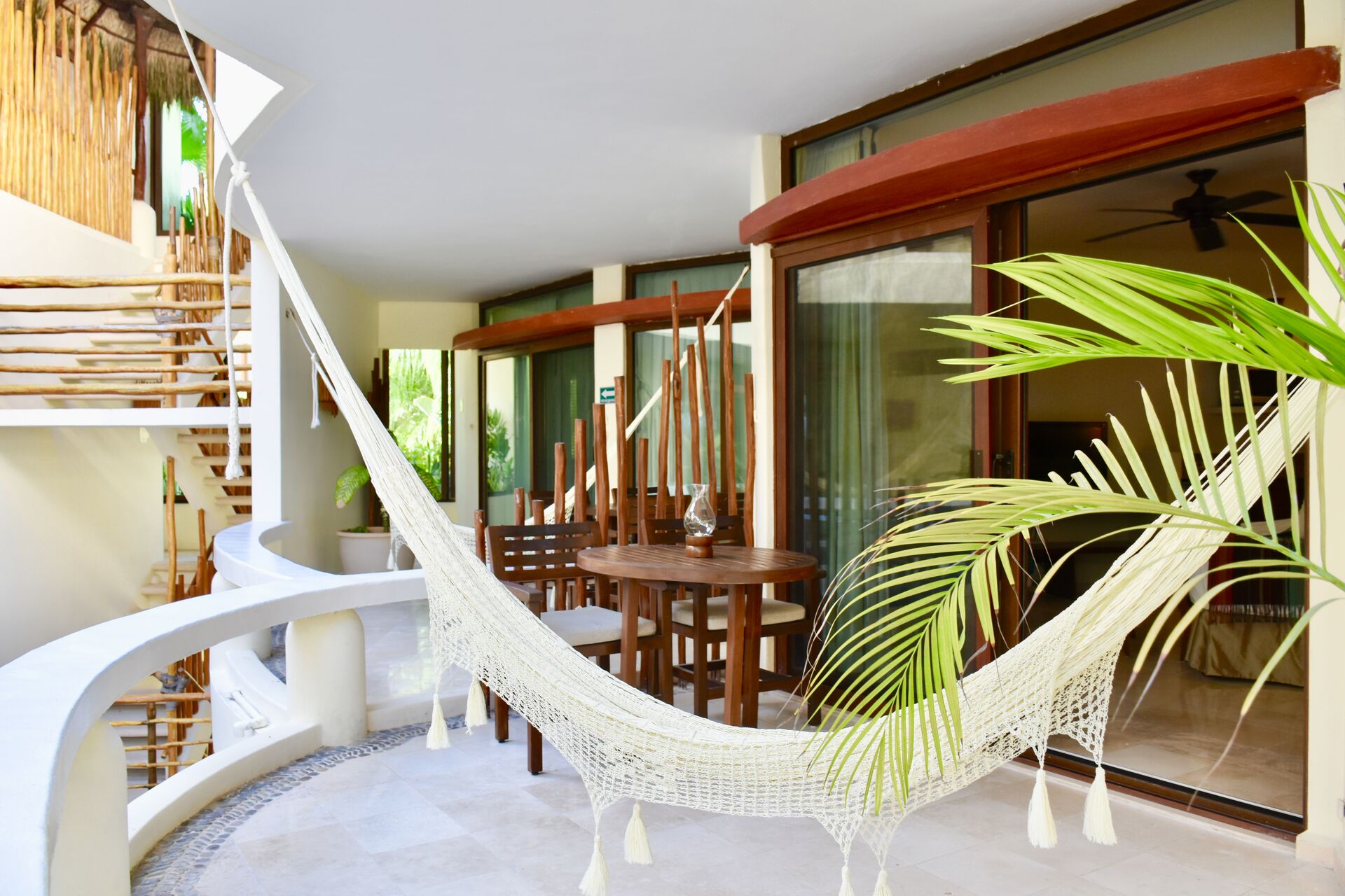 Large private balcony with chairs and hammock.