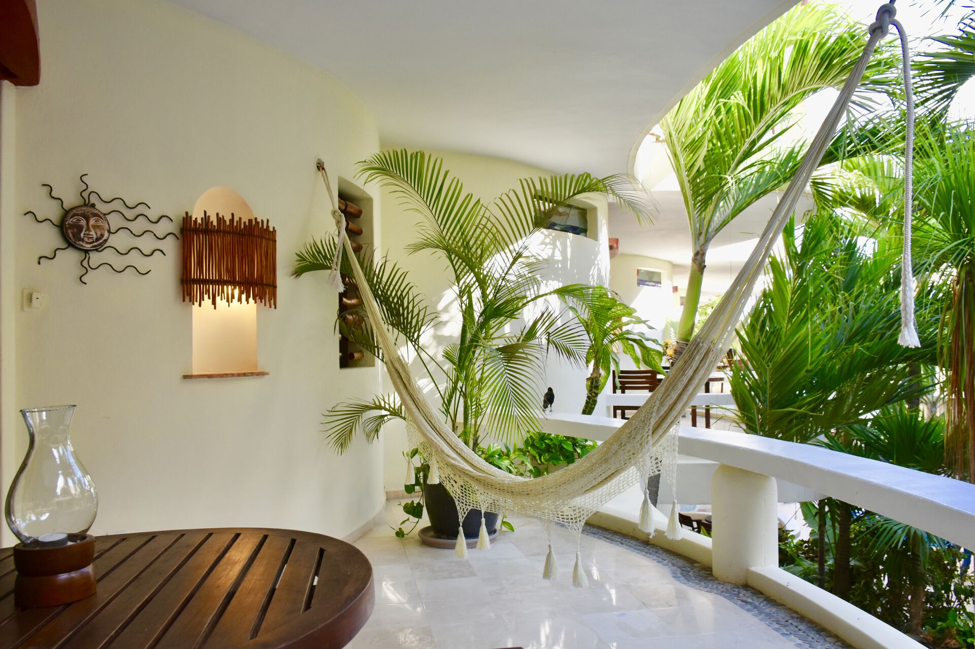 Partial ocean view balcony with chairs and hammock.