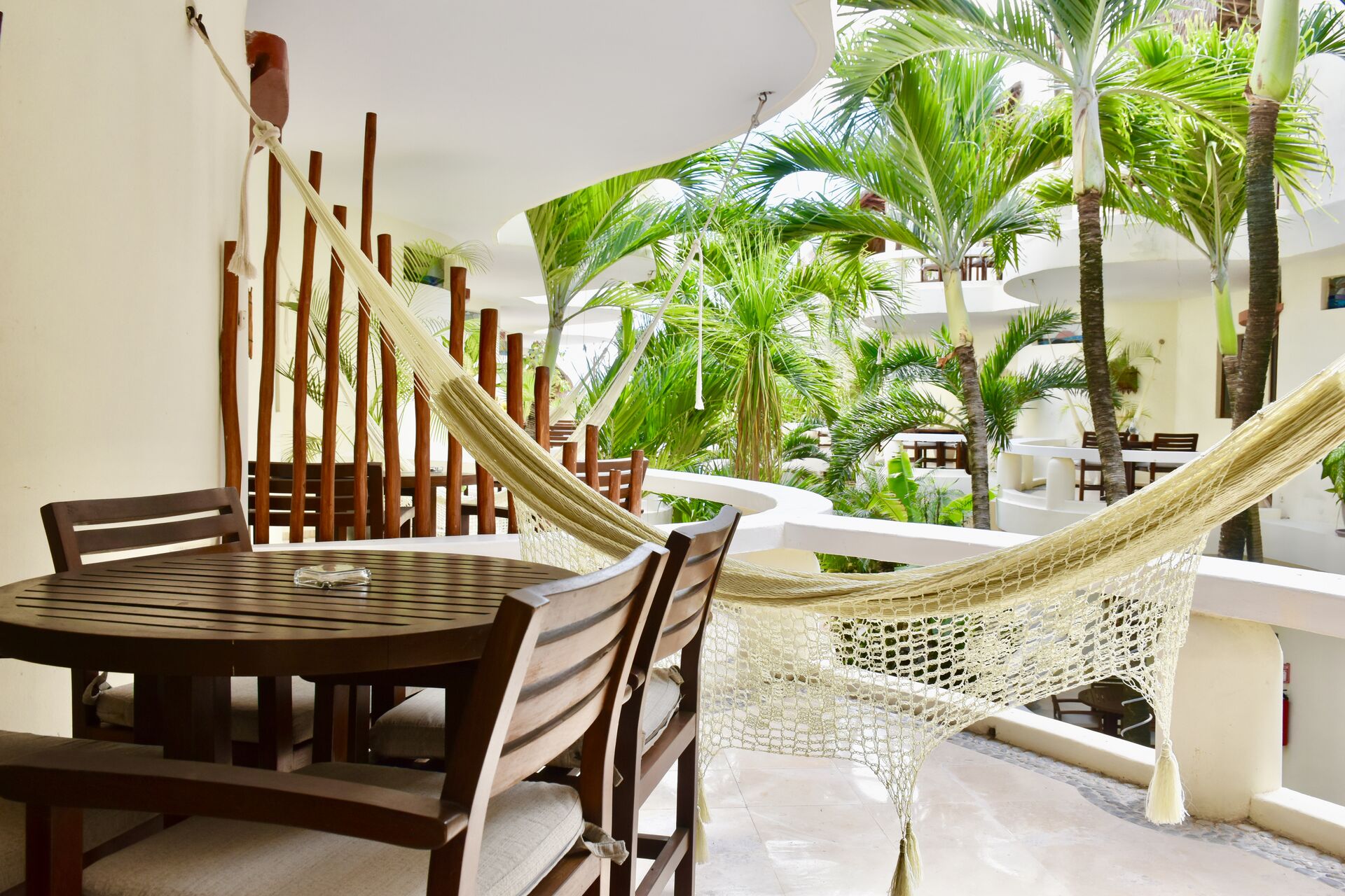 Large balcony with chairs and hammock.