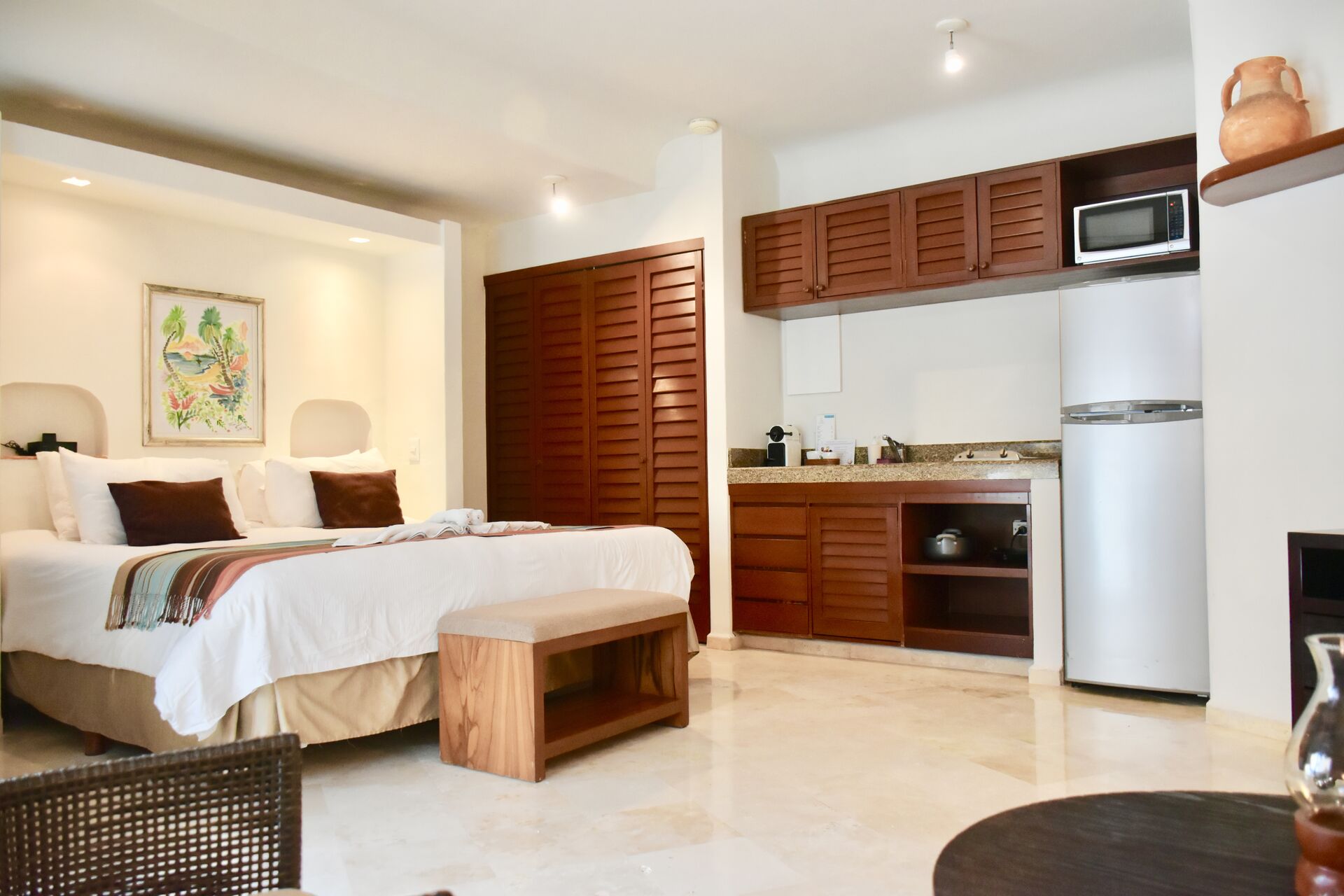 Ocean view room with king size bed and kitchenette.
