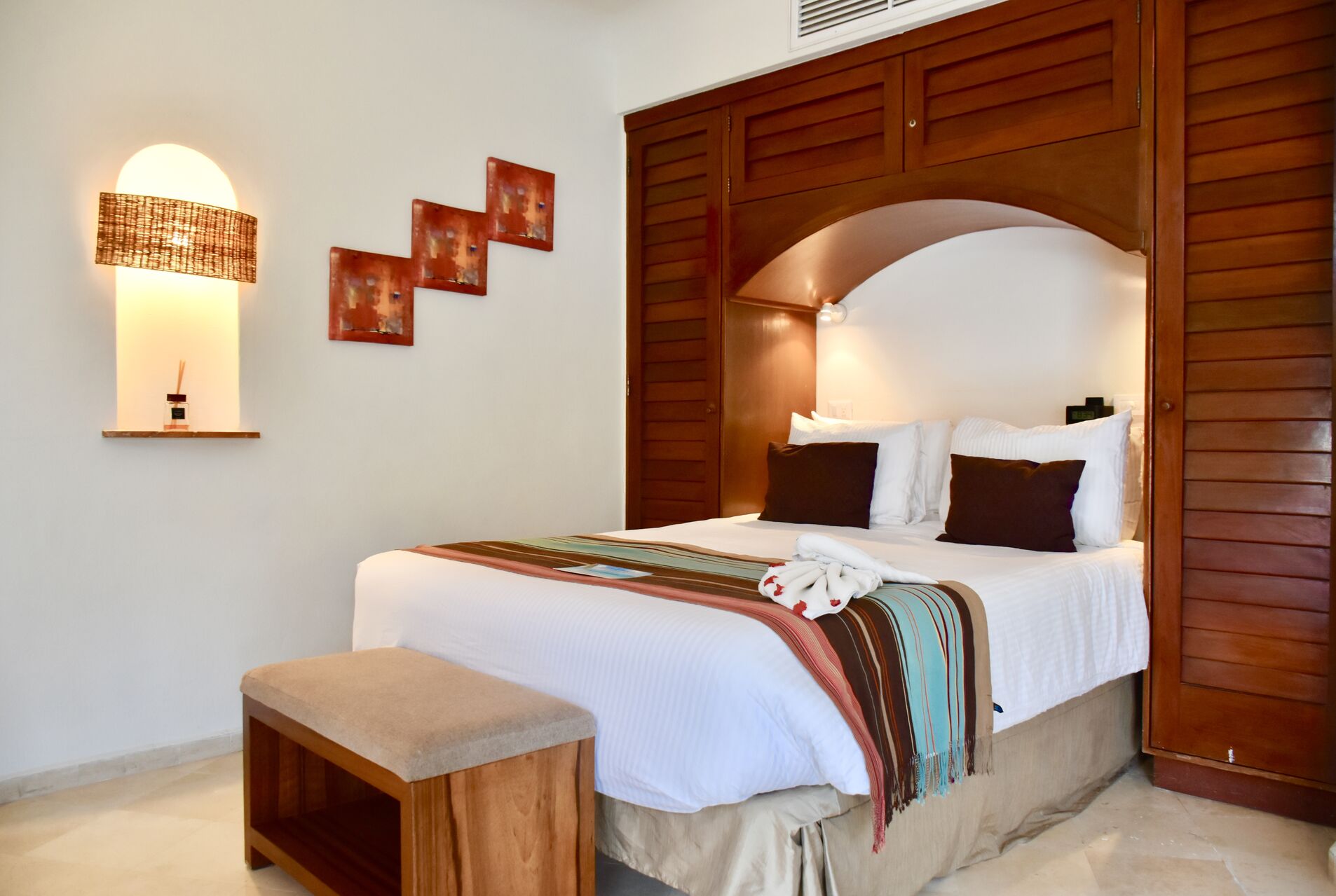 Fully furnished ocean view suite with queen size bed and kitchenette.