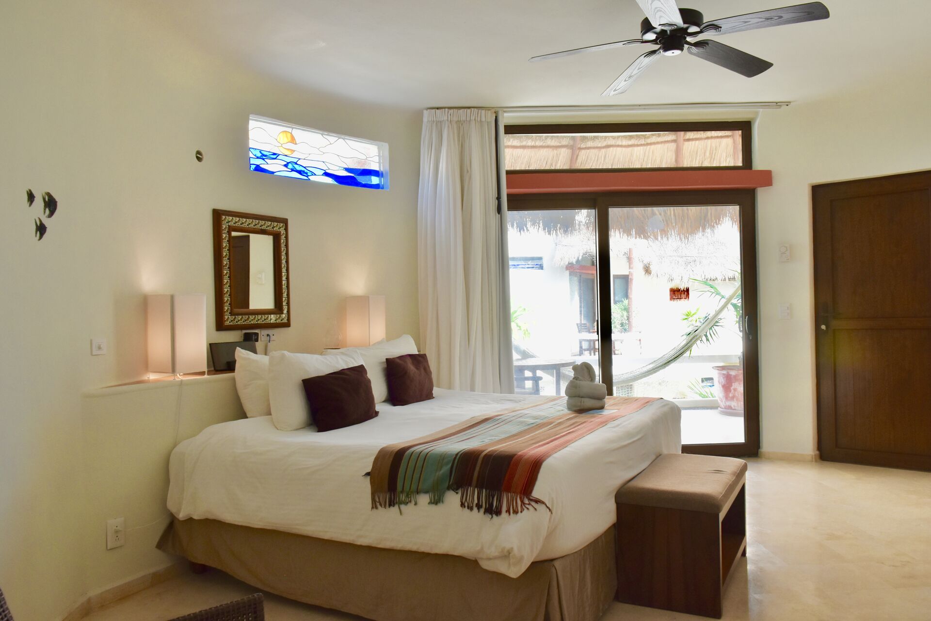 Fully furnished ocean view suite with king size bed and kitchenette.