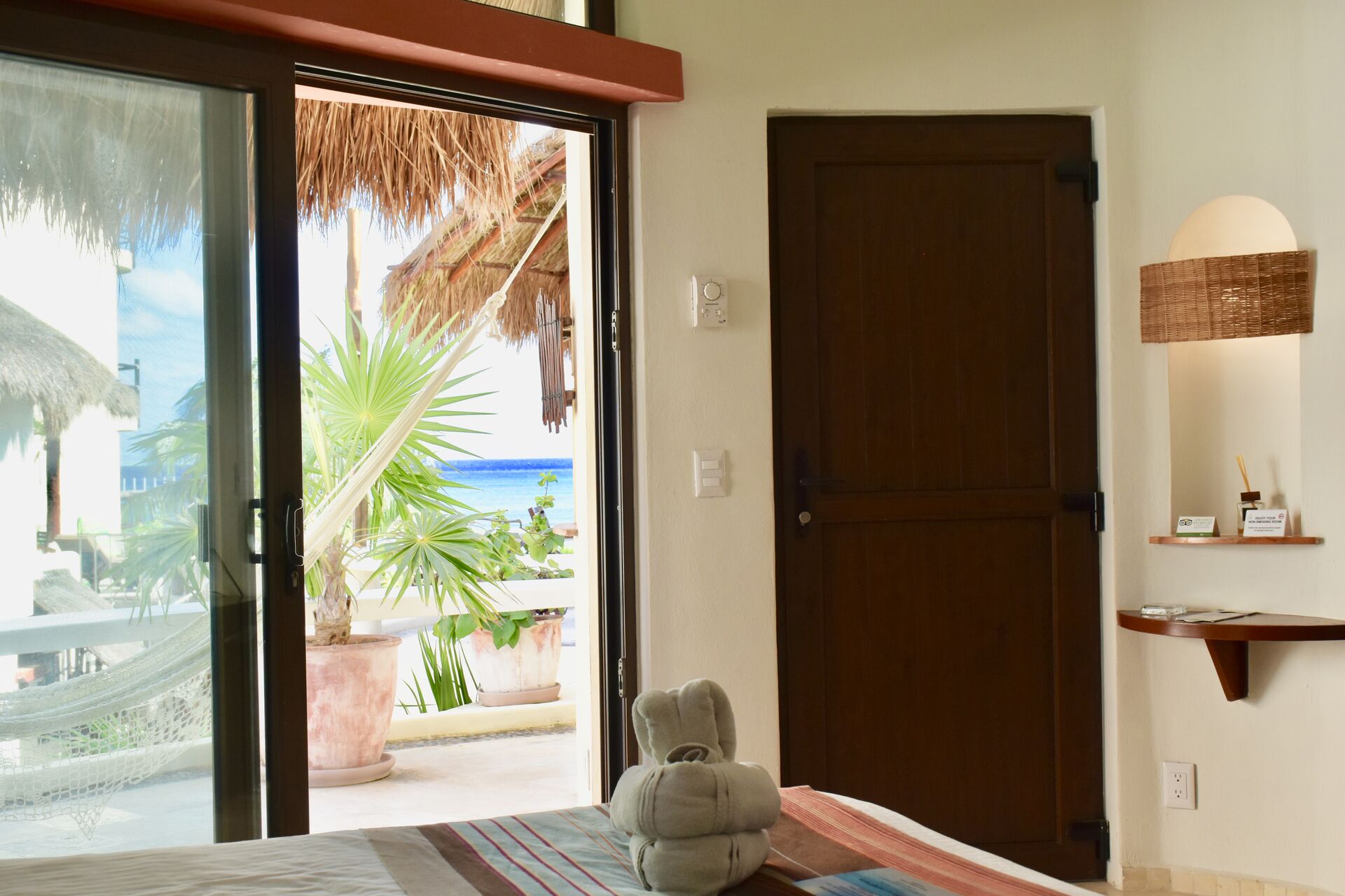 Fully furnished ocean view suite with king size bed and kitchenette.