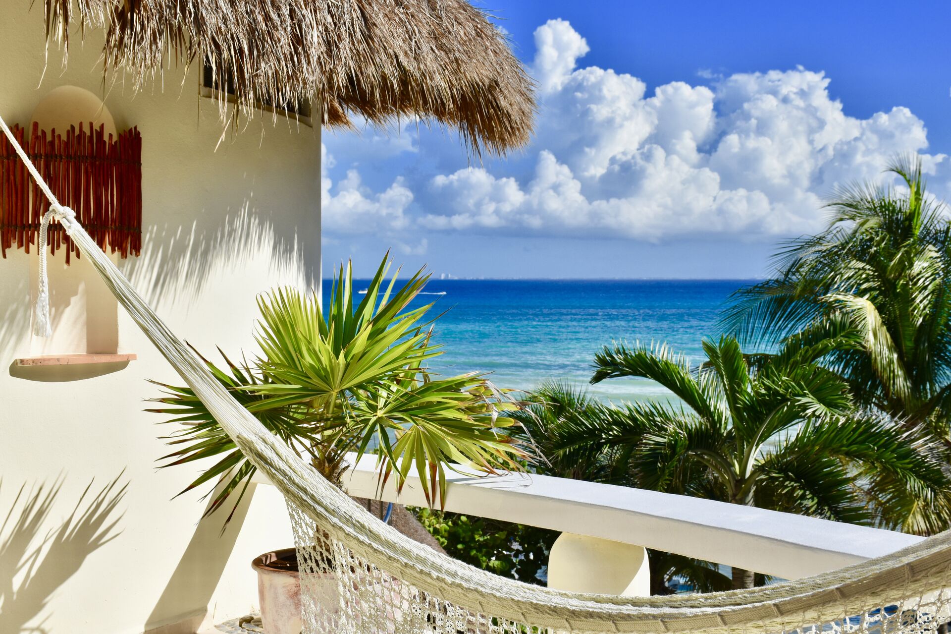 Playa Palms, ocean view balconies with chairs and hammock.
