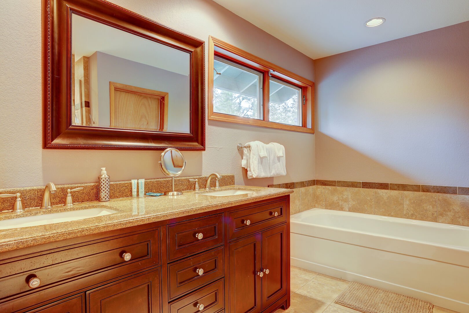 Master bath has twin sinks, extra long bathtub, separate shower and private toilet room.