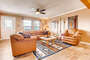 The family room has new comfortable leather seating and gorgeous hard wood flooring.