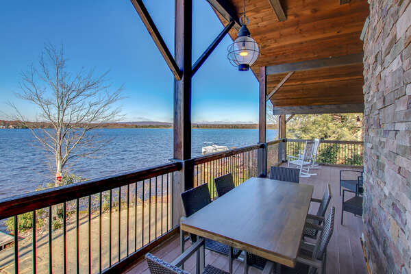 Another picture from the back porch, with porch furniture and a view over the lake.